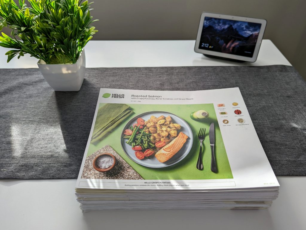 A large stack of HelloFresh paper instructions